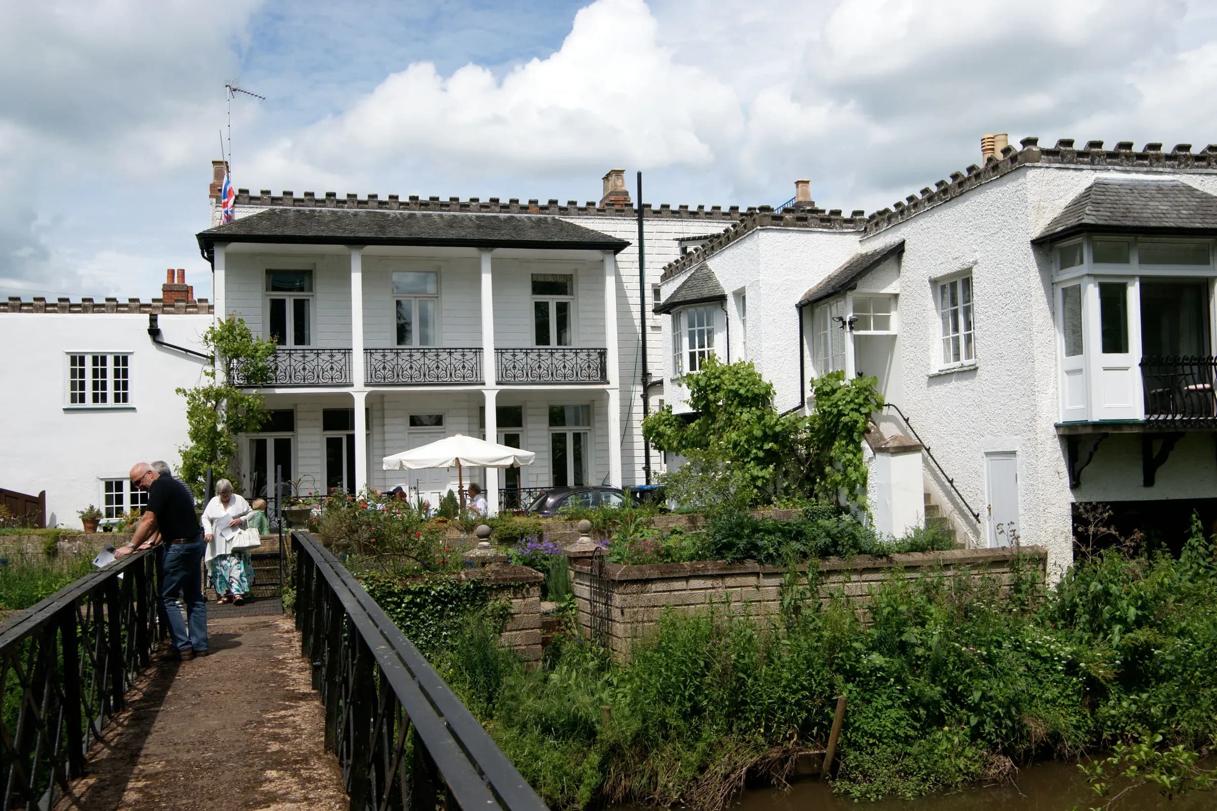 The riverside at Alcester, with the water running past open grass and trees.