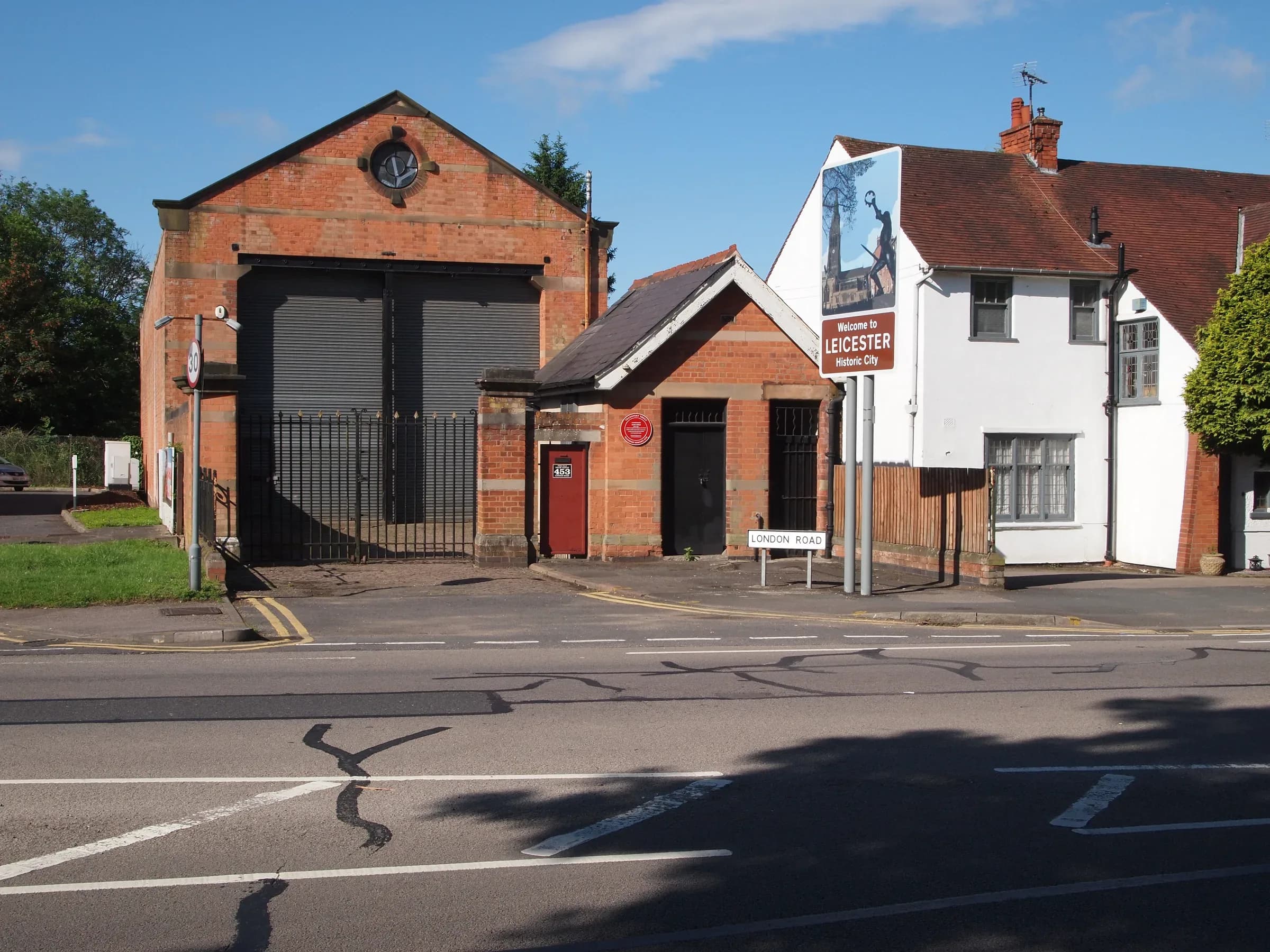 London Road running through Oadby, with shopfronts along one side.
