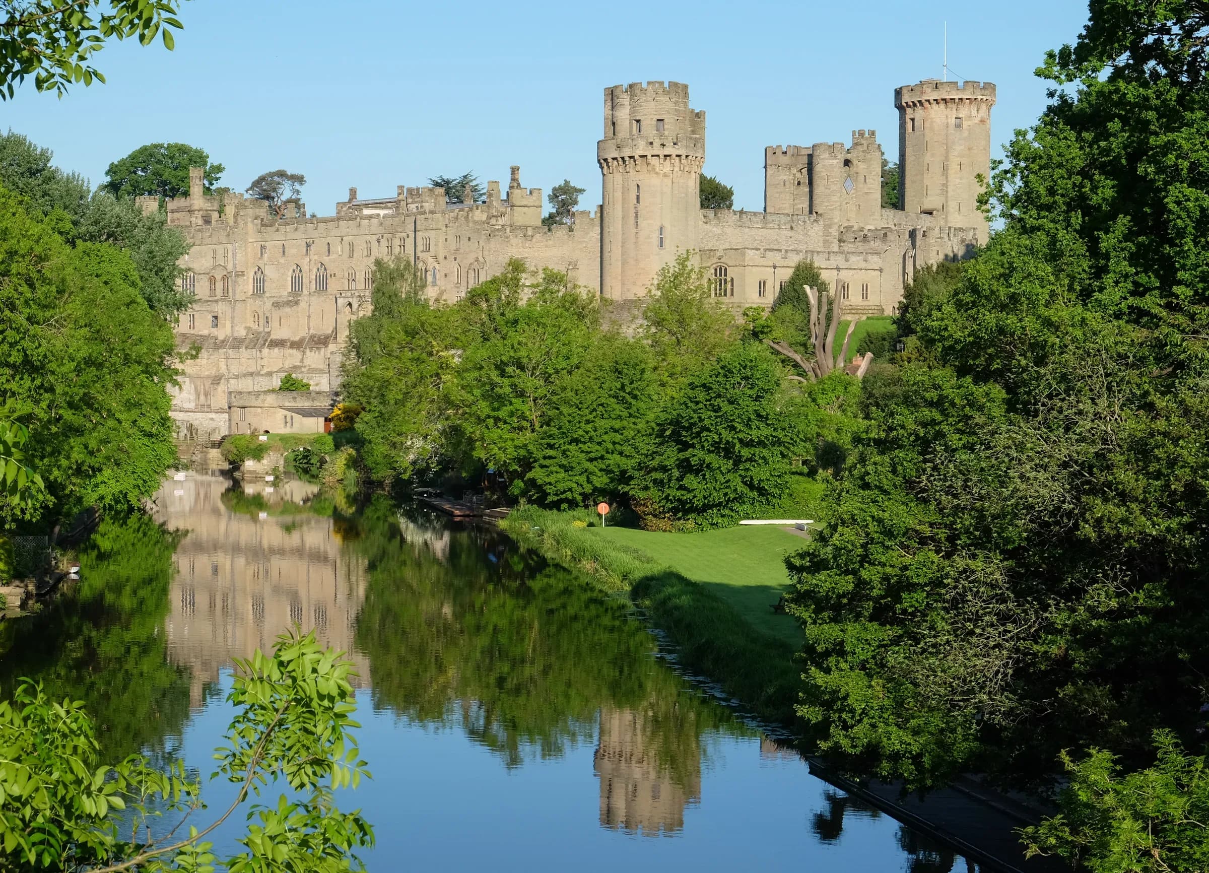 Warwick Castle from across the River Avon on a clear day.
