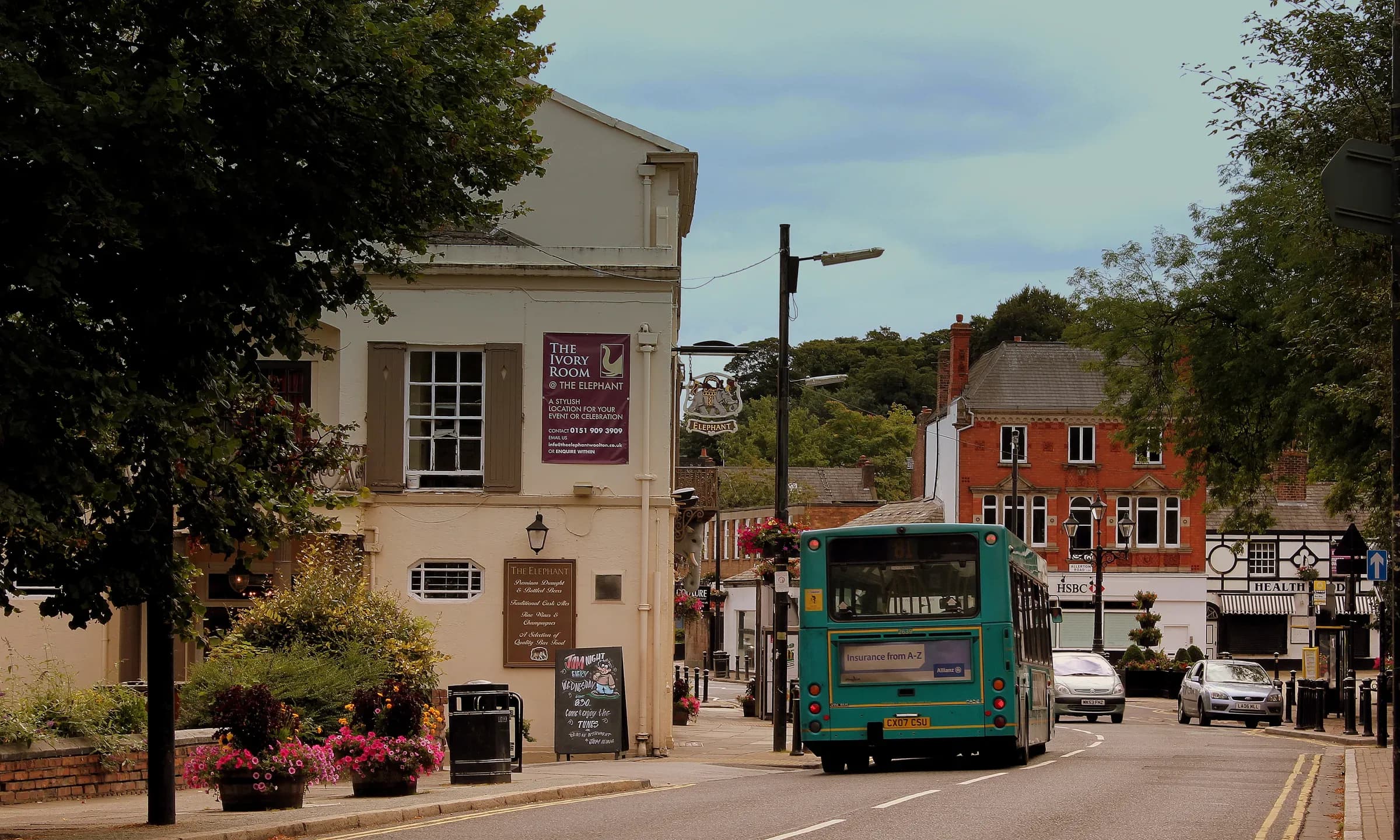 Woolton village in south Liverpool, looking along the sandstone shopfronts.