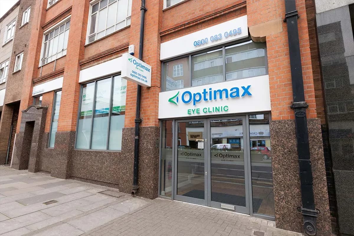 The street frontage of the Optimax eye clinic on Charles Street, Leicester, with its illuminated sign above the entrance.